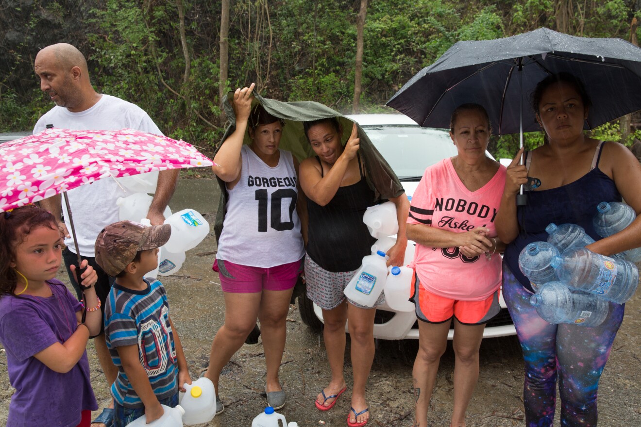 Residents of Salinas wait for the water to be filtered and purified. They lined up in the rain with water jugs and buckets as the news of clean water spreads throughout the town by word of mouth.